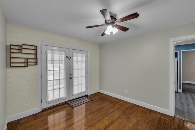 interior space featuring french doors, baseboards, and wood finished floors