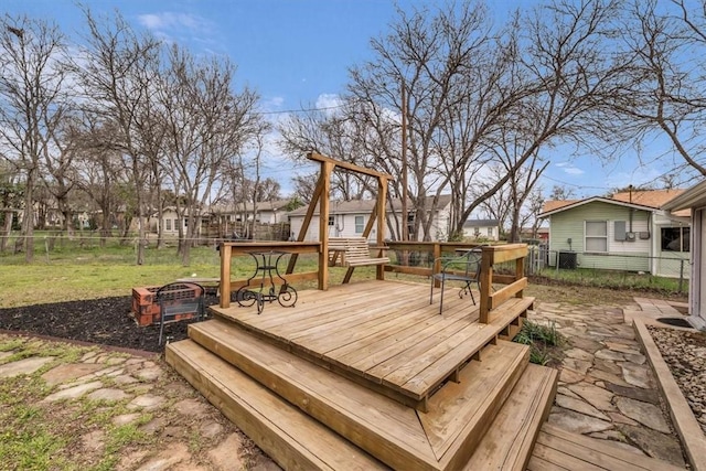 wooden terrace featuring a residential view, a yard, and fence