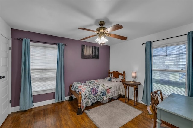 bedroom with baseboards, ceiling fan, and wood finished floors