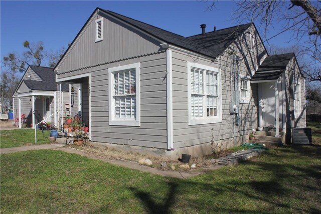 back of property featuring a lawn and a deck