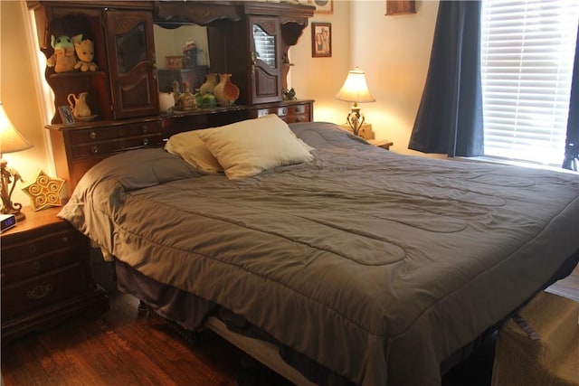 bedroom with dark hardwood / wood-style flooring