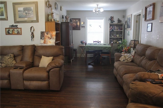 living room with dark wood-type flooring and a chandelier