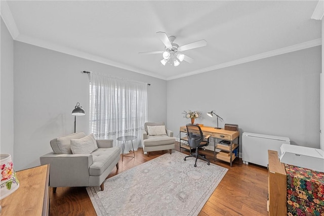 office area featuring a ceiling fan, ornamental molding, and wood finished floors