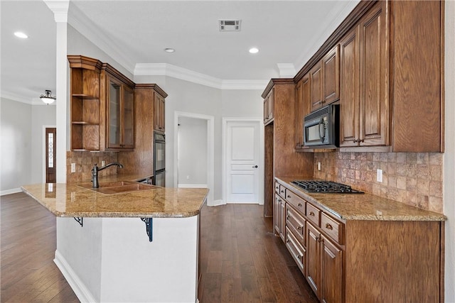 kitchen with visible vents, a peninsula, black appliances, open shelves, and a sink