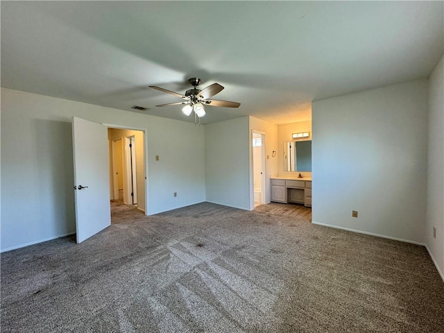 unfurnished bedroom featuring ensuite bathroom, ceiling fan, and carpet floors