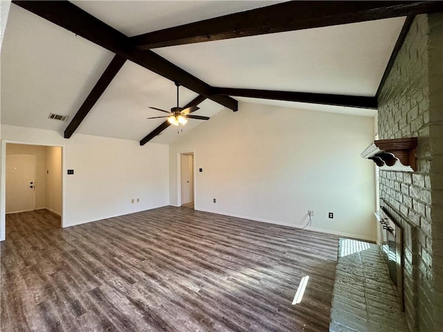 unfurnished living room with lofted ceiling with beams, ceiling fan, wood-type flooring, and a brick fireplace