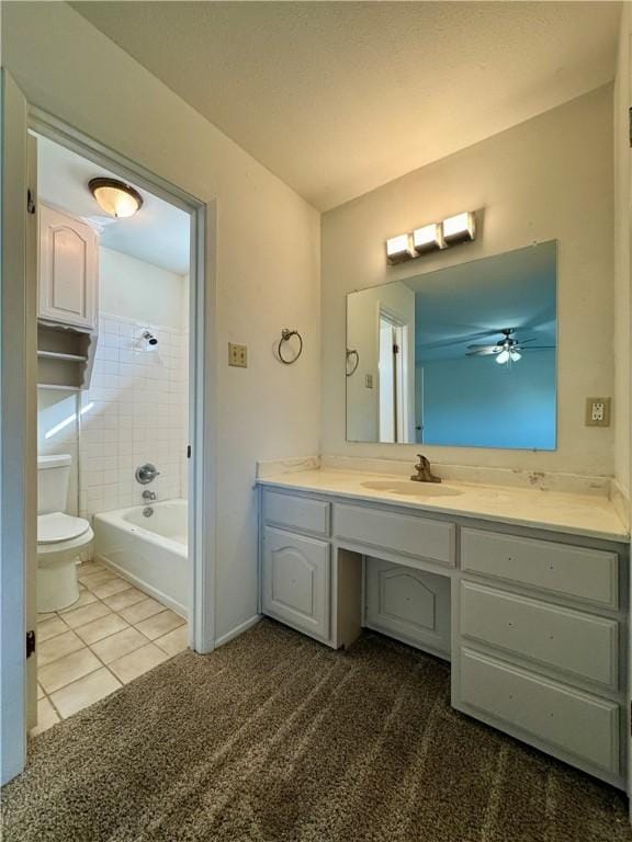 full bathroom with tile patterned flooring, vanity, toilet, and tiled shower / bath