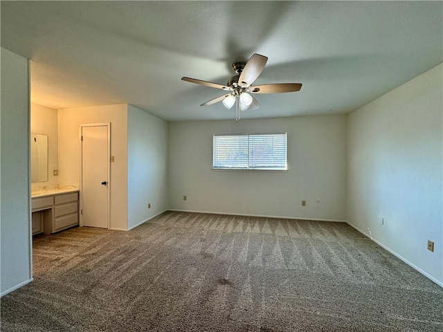 unfurnished bedroom featuring ensuite bathroom, carpet, and ceiling fan