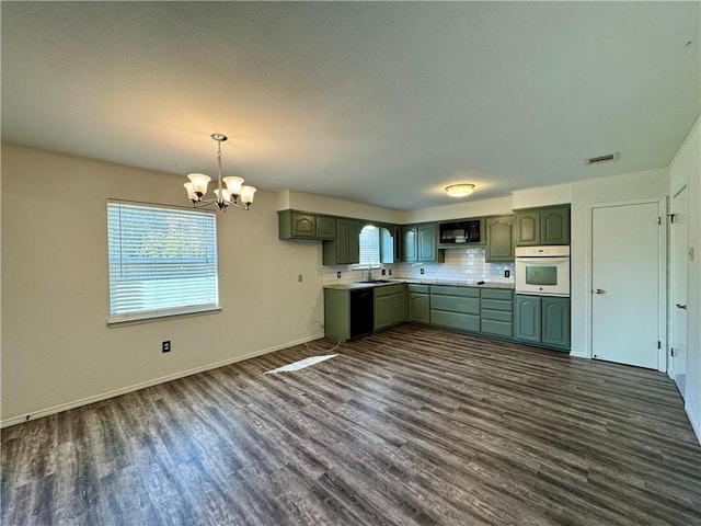 kitchen with green cabinetry, dark hardwood / wood-style floors, a wealth of natural light, and black appliances