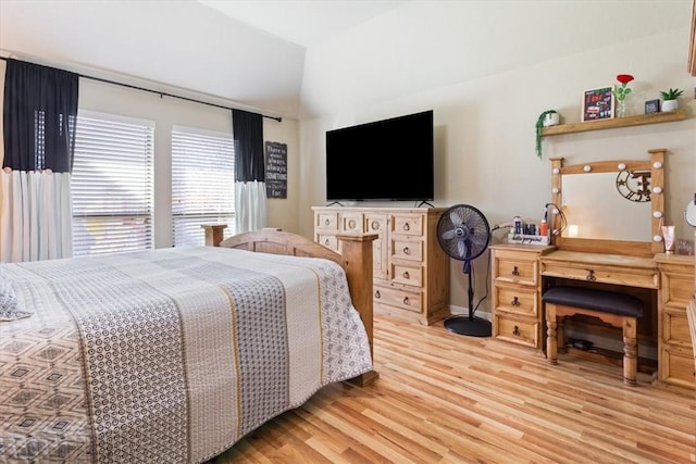 bedroom with vaulted ceiling and light wood finished floors