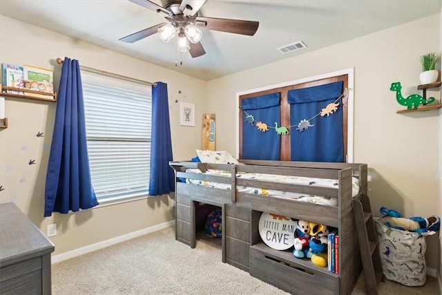 carpeted bedroom with baseboards, visible vents, and ceiling fan