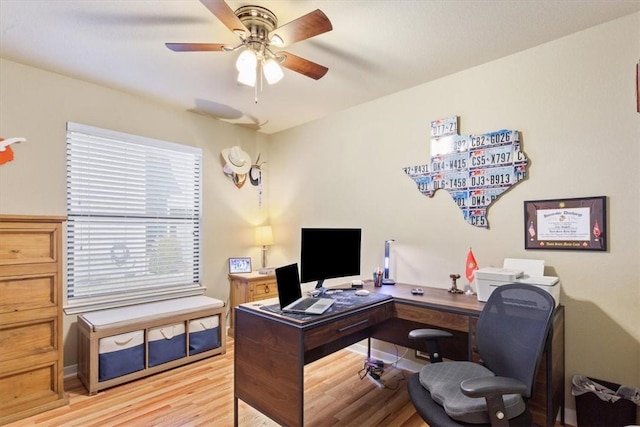 home office featuring light wood-style flooring and a ceiling fan