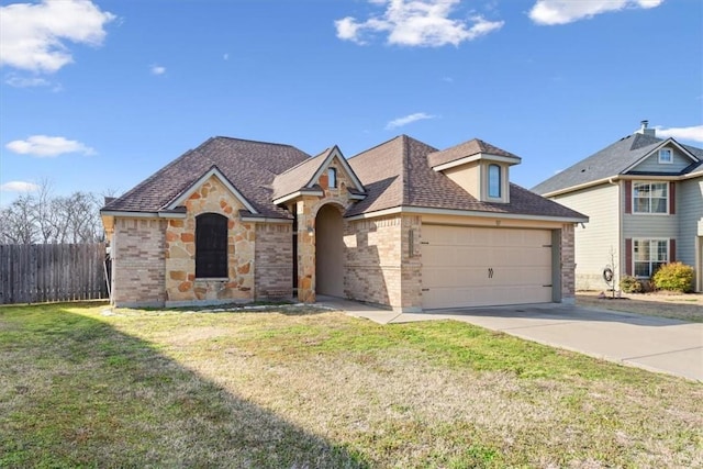 view of front of home featuring brick siding, concrete driveway, a front yard, fence, and a garage