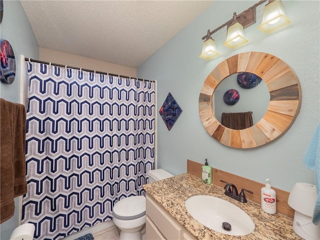 bathroom featuring vanity, a shower with shower curtain, a textured ceiling, and toilet