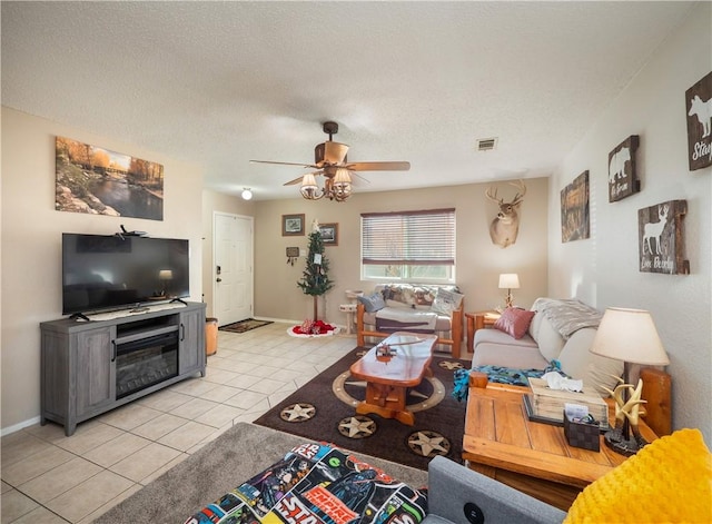 tiled living room featuring ceiling fan and a textured ceiling