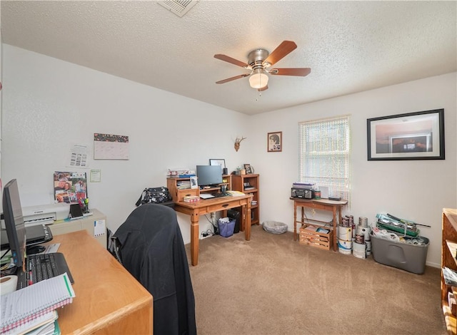 carpeted office featuring ceiling fan and a textured ceiling