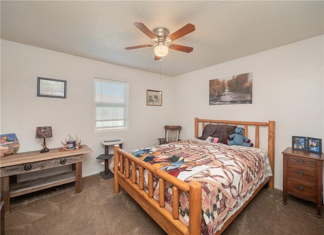 bedroom with a textured ceiling, dark carpet, and ceiling fan