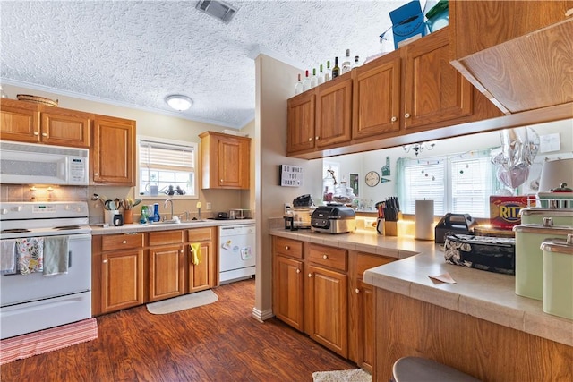 kitchen with white appliances, visible vents, light countertops, and a sink