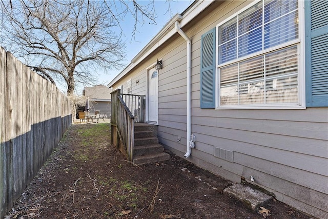 view of property exterior with fence