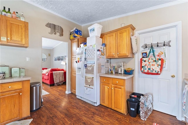 kitchen with dark wood-style flooring, crown molding, light countertops, a textured ceiling, and white fridge with ice dispenser