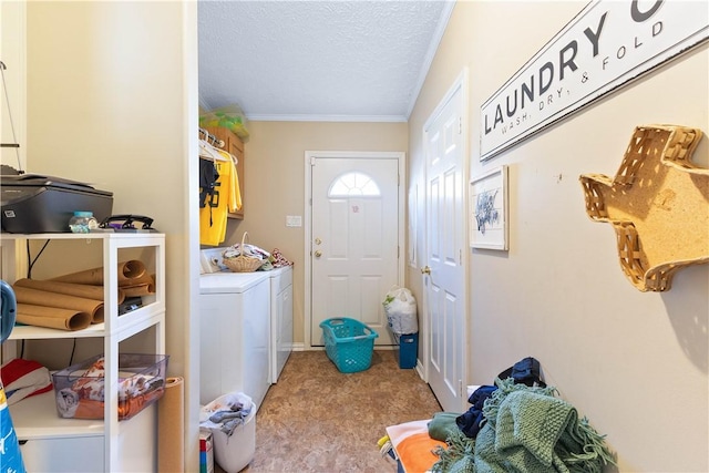 clothes washing area with light carpet, laundry area, washer and clothes dryer, ornamental molding, and a textured ceiling