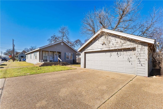 single story home featuring a garage, an outdoor structure, and a front yard