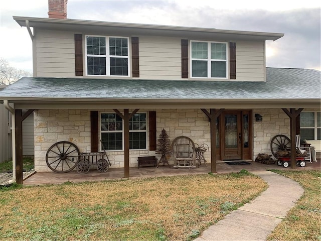 view of front facade featuring covered porch and a front lawn