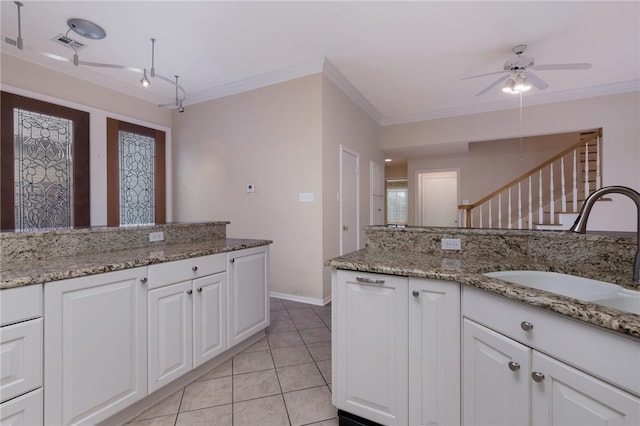 kitchen featuring white cabinets, ceiling fan, crown molding, and sink