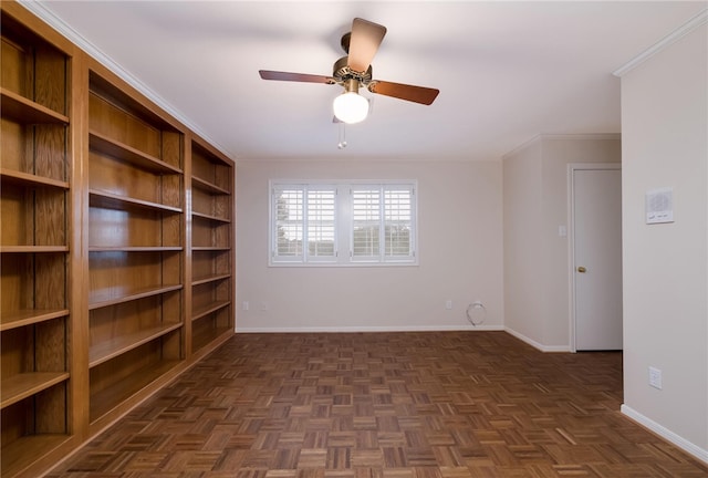 spare room with dark parquet floors, ceiling fan, and ornamental molding