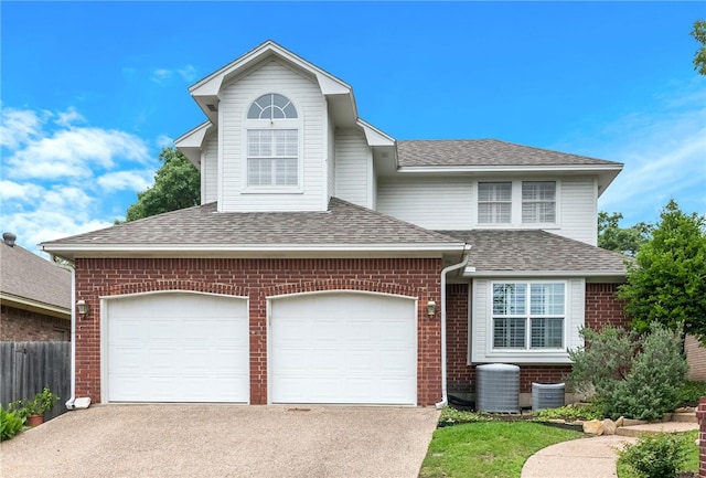 front facade with a garage and central AC unit