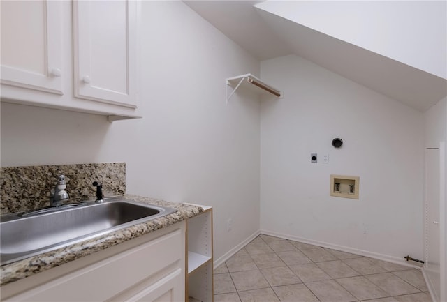 clothes washing area with electric dryer hookup, cabinets, sink, hookup for a washing machine, and light tile patterned floors