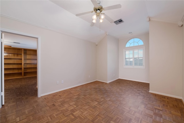 spare room with ceiling fan, dark parquet flooring, ornamental molding, and lofted ceiling