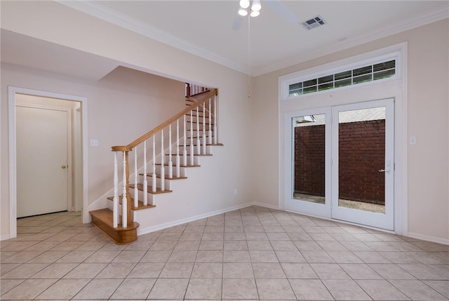 tiled foyer with ceiling fan and ornamental molding