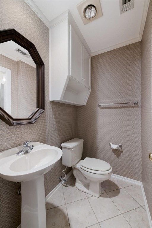 bathroom featuring tile patterned floors, toilet, and ornamental molding