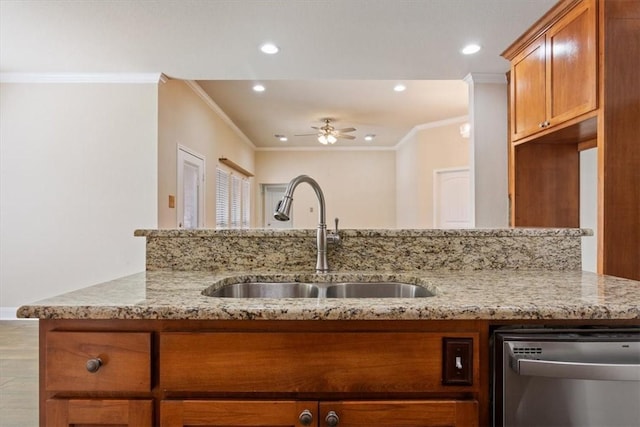 kitchen with ornamental molding, dishwasher, a sink, and light stone countertops