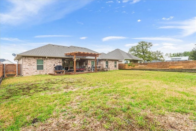 rear view of house with a lawn, a fenced backyard, a patio area, a pergola, and brick siding