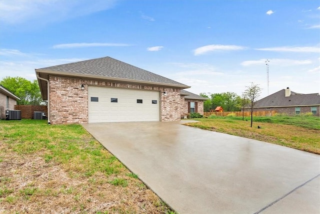 view of front of property featuring central AC, brick siding, a front lawn, and driveway