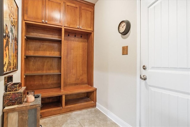 mudroom with light tile patterned floors and baseboards