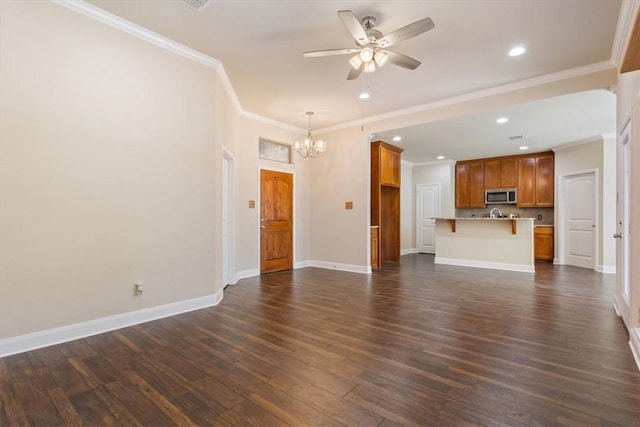 unfurnished living room with recessed lighting, ceiling fan with notable chandelier, dark wood-style flooring, baseboards, and crown molding