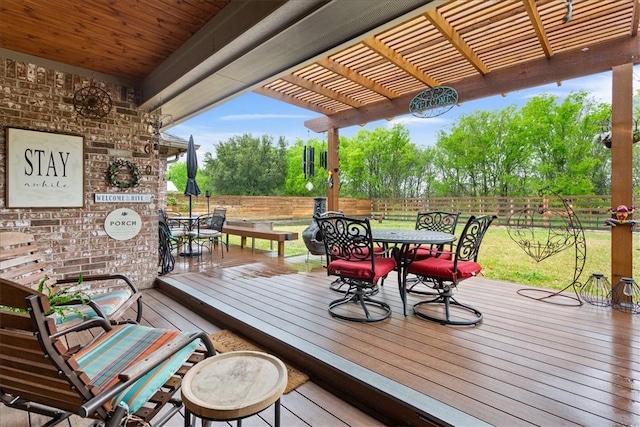 deck with outdoor dining space, fence, and a pergola