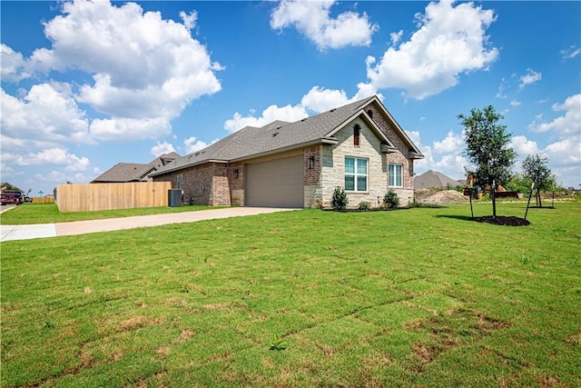 view of front facade with central AC unit, a garage, and a front lawn