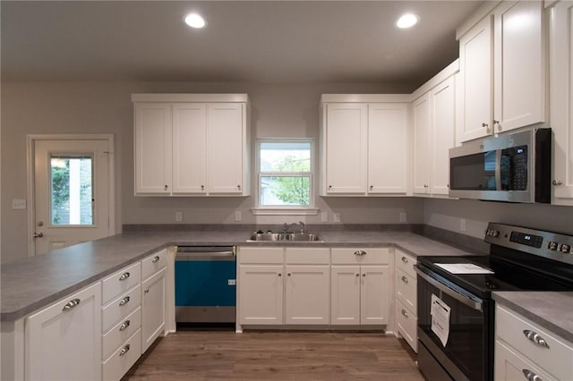 kitchen featuring sink, white cabinetry, stainless steel appliances, and a healthy amount of sunlight