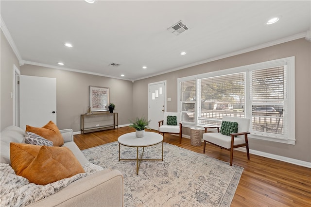 living area with recessed lighting, visible vents, baseboards, and wood finished floors