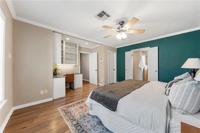 bedroom featuring visible vents, crown molding, ceiling fan, baseboards, and light wood-type flooring