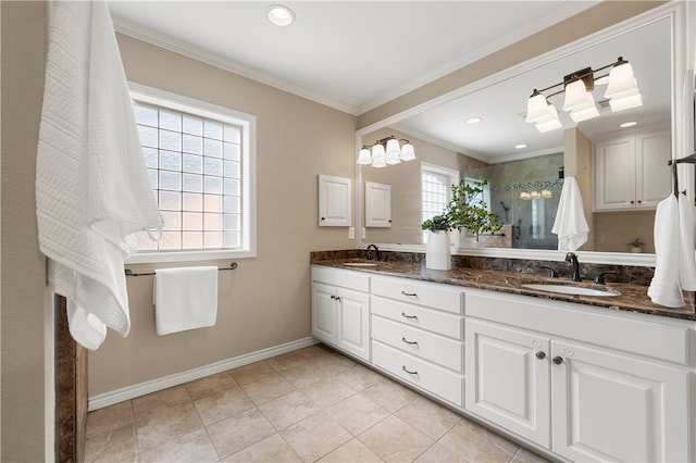 bathroom featuring crown molding, baseboards, a stall shower, and a sink