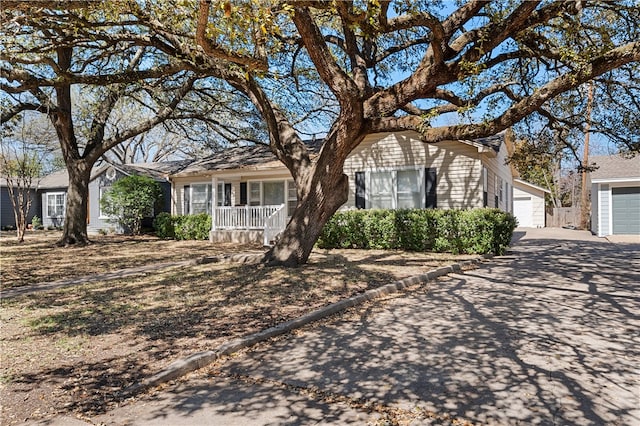 view of front facade with a porch and a garage