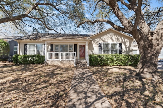 single story home featuring covered porch