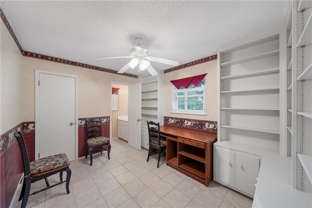 office featuring a textured ceiling, ceiling fan, and light tile patterned flooring