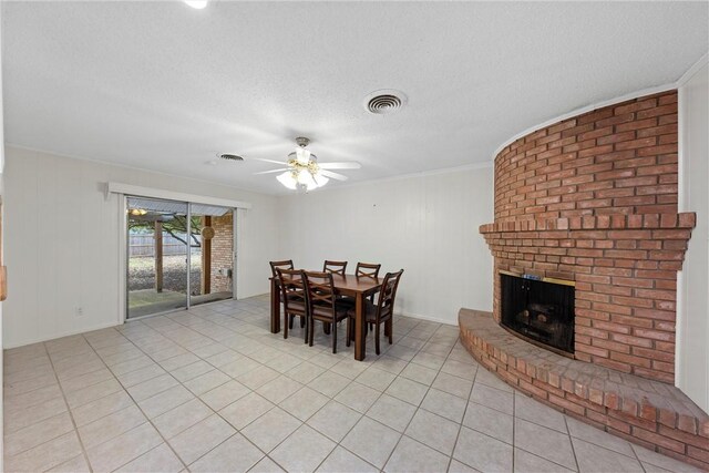 dining space with ceiling fan, ornamental molding, and light tile patterned flooring