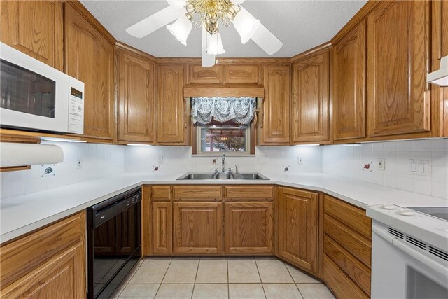 kitchen featuring white appliances, sink, ceiling fan, light tile patterned floors, and tasteful backsplash